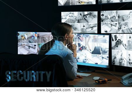 Security Guard Monitoring Modern Cctv Cameras Indoors At Night