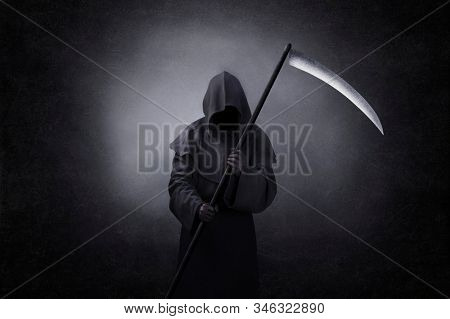 Grim reaper with scythe in the dark