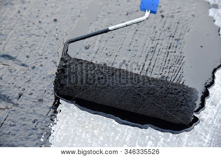 Worker Applies Bitumen Mastic On The Foundation