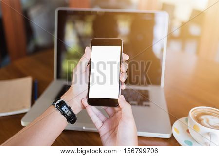 girl using smart phone in cafe. hand holding smart phone white screen. black color smart phone vintage tone. hand holding using mobile phone on sunset.