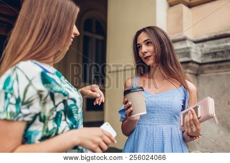 Two Young Beautiful Women Talking Drinking Coffee. Girls Having Fun In City. Best Friends Chat Outdo