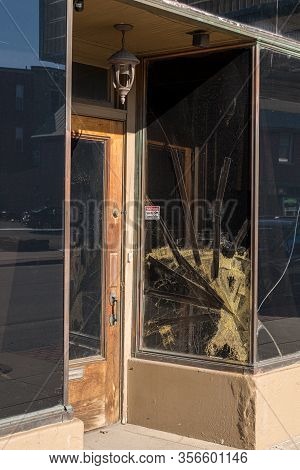 Cracked Glass Window Pane By Shop Door Looking Like Rioters Have Tried To Enter The Store