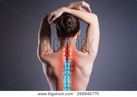 Pain In The Spine, Woman With Backache On Gray Background, Back Injury, Photo With Highlighted Skele