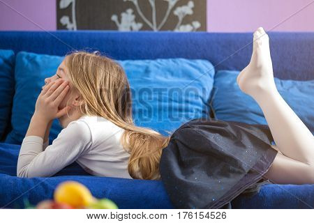 Young little girl lying in bed at home