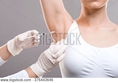 Woman Receiving Underarm Treatment Against Hyperhidrosis. Armpit Injections To Prevent Excessive Swe