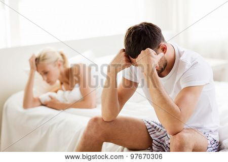 people, relationship difficulties, conflict and family concept - unhappy couple having problems at bedroom