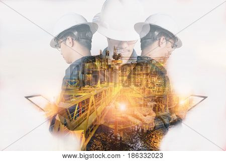 Double exposure of Engineer or Technician man with safety helmet operated platform or plant by using tablet with offshore oil and gas platform background for oil and gas business concept