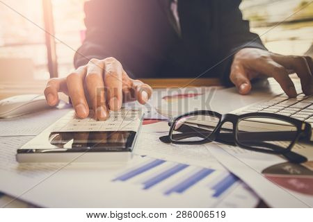 Businessman Or Accountant Working On Calculator To Calculate Business Data Concept. Accounting,inves