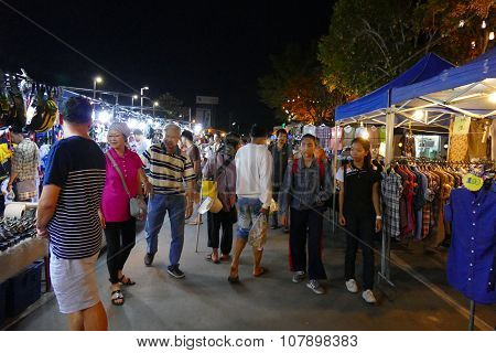 People Walking And Shopping At The Night Market