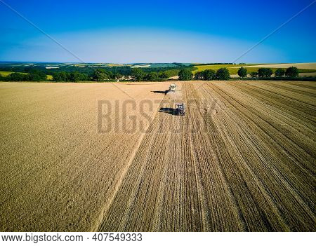 Aerial View On Combine Harvester Gathers The Wheat At Sunset. Harvesting Grain Field, Crop Season. V