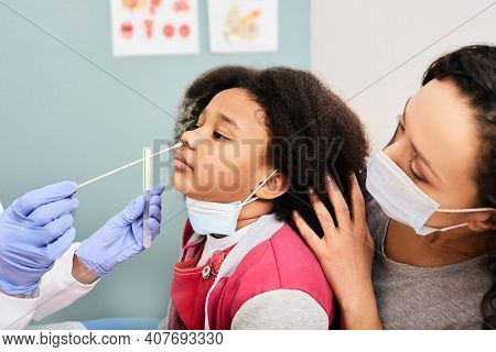 African American Little Girl With Her Mother During Pcr Test Of Covid-19 In A Medical Lab. Physician