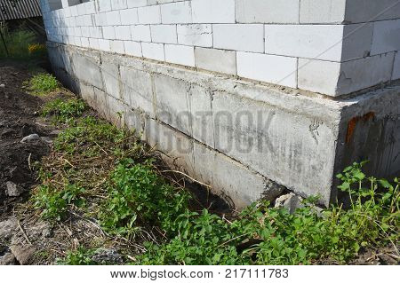 Close up on Waterproofing and insulation house foundation wall. Foundation Waterproofing and Damp proofing Coatings. Waterproofing house foundation with bitumen spray on tar