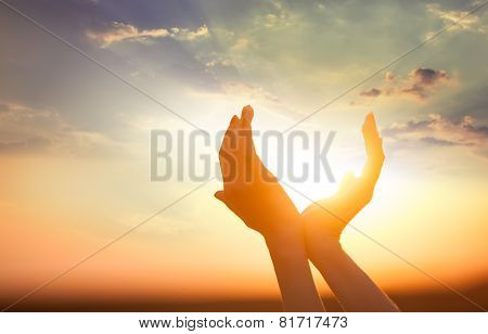 Hands Holding The Sun At Dawn