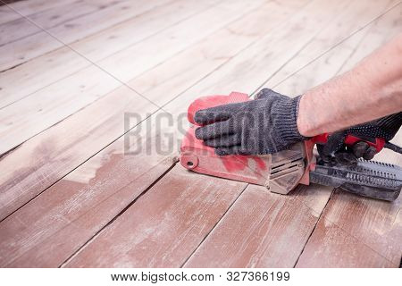 Wood Floor Polishing Maintenance Work By Grinding Machine. Copy Space. Repair In The Apartment.speci