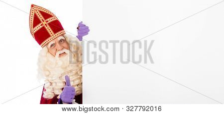 Sinterklaas or saint Nicholas holding blank cardboard. isolated on white background. Dutch character of Santa Claus