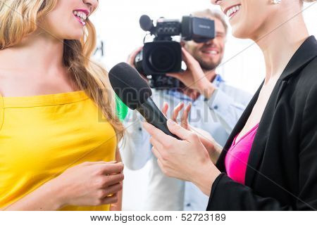 Reporter and cameraman film shoot actress interview on film set for TV or  Television 