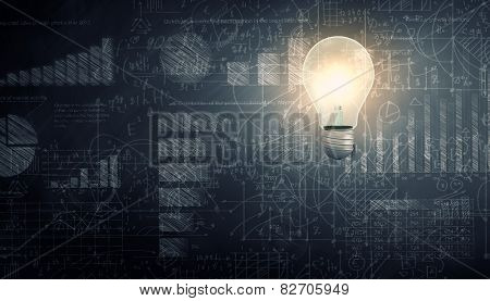 Glowing light bulb with sketches at background