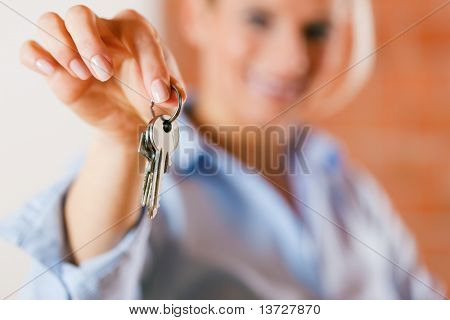 Realtor is giving the keys to an apartment to some clients ÃÂ¢Ã?Ã? focus on the keys