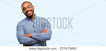 African american man with beard with crossed arms confident and happy with a big natural smile laughing isolated over blue background