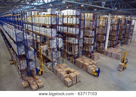 Interior Large Warehouse With Freight Stacked High.