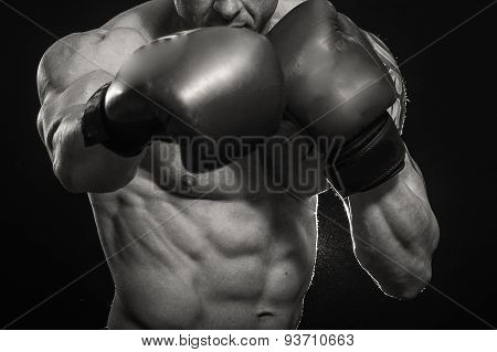 A man with a tattoo in red boxing gloves