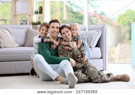 Woman In Military Uniform With Her Family At Home