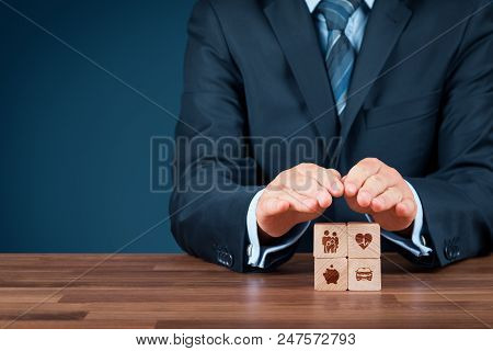 Insurance Concept. Businessman With Protective Gesture And Insurance Icons On Wooden Cubes: Family A