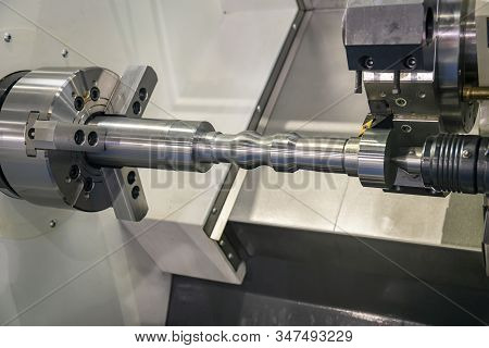 The Cnc Lathe Machine In Metal Working Process Cutting The Metal Shaft Parts With In The Light Blue 