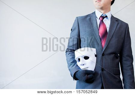 Business Man Carrying White Mask To His Body Indicating Business Fraud And Faking Business Partnersh