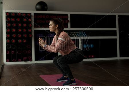 Muscular Woman Doing Cross Fit Workout At Gym. Image Of Sporty Athletic Woman In Sneakers And Tracks