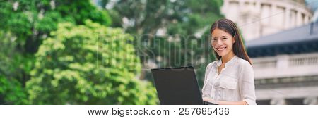 Asian woman working on laptop computer laptop at outside cafe city park, Hong Kong, China. Young student sitting outdoor, freelancer or remote work on Asia travel. Banner panorama.