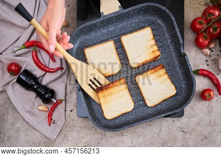 Sliced Bread Fried On Grill Frying Pan At Domestic Kitchen