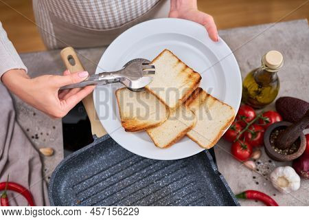 Sliced Bread Fried On Grill Frying Pan At Domestic Kitchen