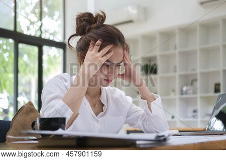 Stressed Female Employee Feeling Tired At Work, Suffering From Headache, Stress At Work Or Migraine.