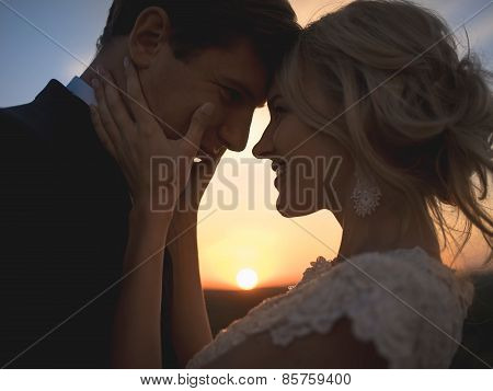 Close portrait silhouette in love wedding couple. Against the se