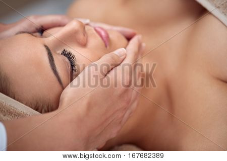 Close-up of a young woman getting spa treatment at beauty salon. spa face massage. facial beauty treatment. spa salon.