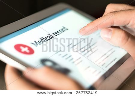 Electronic Medical Record With Patient Data And Health Care Information In Tablet. Doctor Using Digi