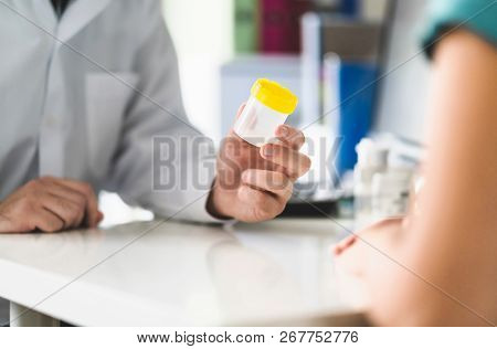 Doctor, Patient And Urine Test Cup. Physician Giving Pee Container To A Woman In Clinic Or Hospital 