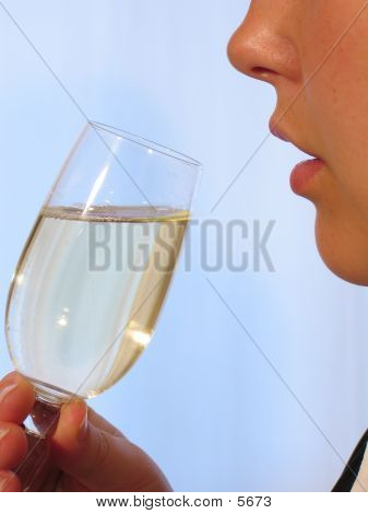 A Woman With A Glass Of Sparkling Wine.