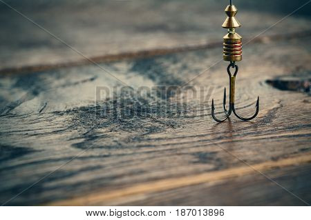 fishing hooks on ols wooden table Tri-hook for fishing