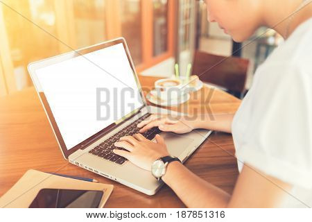 Female working on laptop in a cafe. woman using laptop in home. using laptop internet. hand using laptop in coffe shop. white screen. Business entrepreneur asian girl working online on laptop in cafe. business entrepreneur asian using laptop in home.