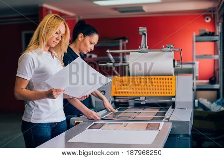 Two Young Woman Working In Printing Factory