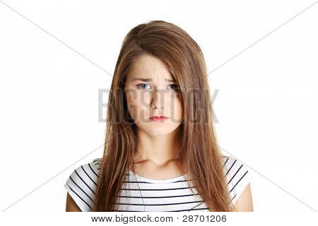 Portrait of a young sad female caucasian teen, on white.