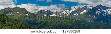 Tops of mountains range with snow caps. Greater Caucasus Mountain Range. Karachay-Cherkessia. Russia.