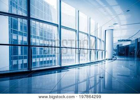 modern building corridor with glass windows,blue toned,china.