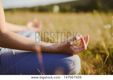 Woman Practices Yoga And Meditates In The Lotus Position On The Nature.  Girl Meditate At The Mounta