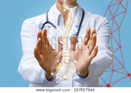 A Doctor Is Operating With An Artificial Spine With Pelvis Unite Inside Digital Wireless Connections