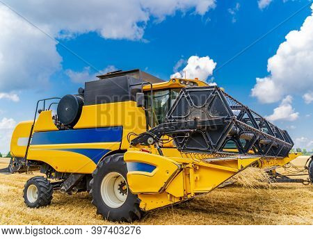 Special Machine Harvesting Crop In Fields, Agricultural Technic In Action. Ripe Harvest Concept. Cro