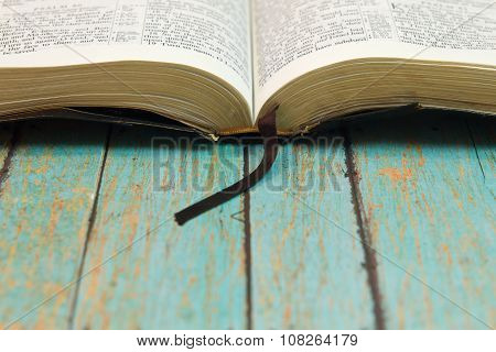 Opened Bible With A Bookmark On Wood