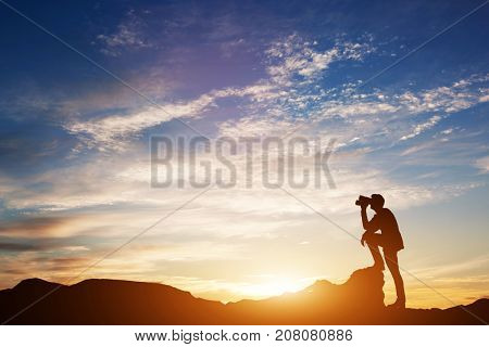 Man standing on rocks, looking through binoculars. Looking forward into the future. Sunset scenic sky. 3d illustration.